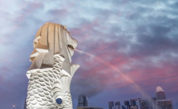 The Merlion of Singapore and the city skyline at sunset
