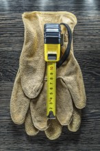 Tapeline safety gloves on wooden board