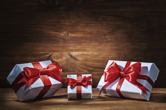 Giftboxes with red ribbons on vintage wood