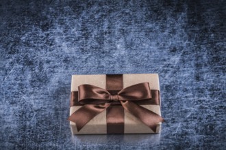 Vintage present box on scratched metallic background holidays concept