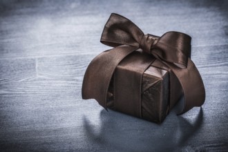 Giftbox shining paper on vintage wooden board holiday concept