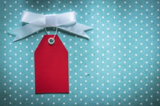 Sale tag on blue polka-dot tablecloth