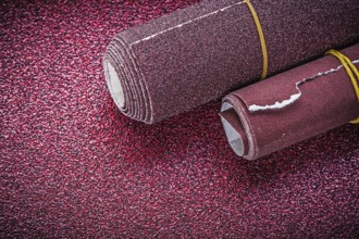 Rolls of polishing paper on abrasive sheet construction concept