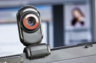 Webcam on monitor, in the background a screen with a portrait of a woman, Federal Republic of