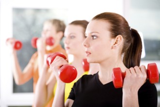 Young women exercising in a step aerobics class