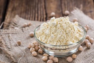 Chick Pea Flour on dark rustic background (close-up shot)