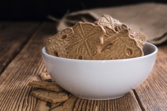 Heap of fresh baked Spekulatius (German cuisine) on wooden background
