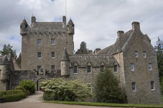 A medieval castle with impressive stone walls and towers, surrounded by trees, inverness, scotland,
