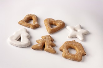 Gingerbread cookies in sugar glaze lie on a white background