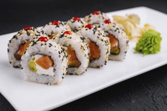 Food, Delicious sushi rolls with salmon, avocado, and sesame seeds served on a sleek plate,
