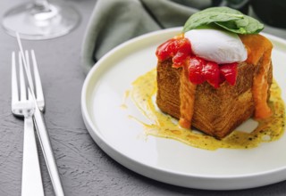 Food, Elegant brunch dish featuring a poached egg on top of french toast with a red pepper sauce