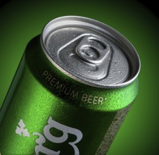 Almaty, Kazakhstan - October 11, 2019: can of beer Carlsberg with drops of water in a green