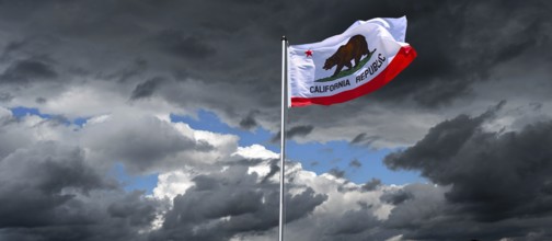 Dramatic sky with national flag of California in strong wind