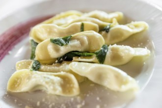 Scarpinocc are typical ravioli from Bergamo, with a characteristic flattened shape. They differ