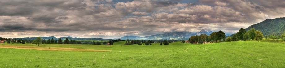Panoramic picture in Allgäu / Bavaria with overcast sky in summer, panoramic composed from multiple