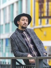 Portrait of a stylish handsome young man with a coat outdoors. A man wearing a coat and a shirt