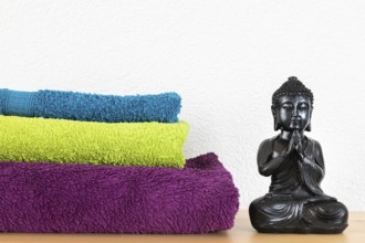 An image of a Buddha figure and towels background