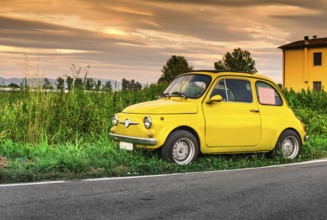 Small vintage italian car Fiat Abarth. Yellow color