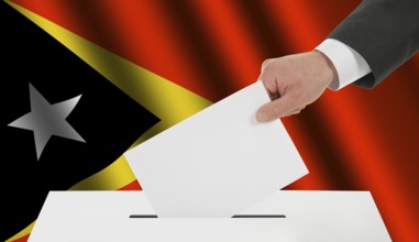 The East Timor flag and the hand with the bulletin about the ballot box
