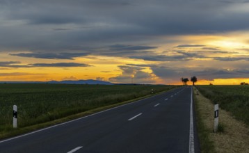 Sunset with long straight country road