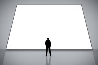 A man in front of a big white empty screen