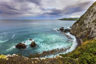 New Zealand. The picturesque coast of the Pacific Ocean near Nugget Points. Sunset sky portends a