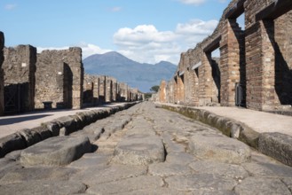 POMPEII, ITALY, MAY 04, 2022, A crosswalk of a typical Roman road in the ancient city of Pompeii,