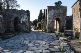 POMPEII, ITALY, MAY 04, 2022, A beautiful typical cobbled street in the ancient city of Pompeii,