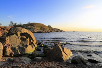Waterfront view to Gulf of Finland near sunset time in October with seaside rocks, blue sea and