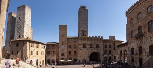 Main square Piazza del Duomo in San Gimignano with its famous palace towers, Italy