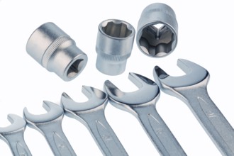 Various tools of a craftsman lie next to each other on a white background