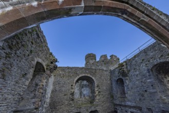 Conwy Castle, ruined stone walls and arch of the castle with a view of the sky, Conwy, Wales, Great