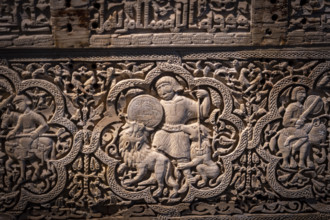 A man on foot, armed with a spear and buckler, rained down against two lionsn Spanish-Arab chest of