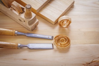 Woodworkers plane and carpentry chisels on wooden boards horizontal version