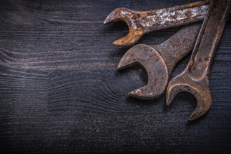 Vintage grunge open-end wrenches on wood board construction concept