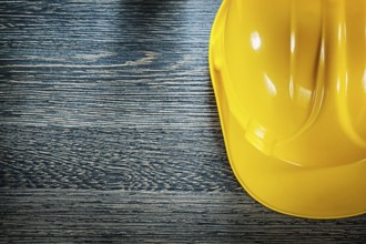 Safety building helmet on wooden board