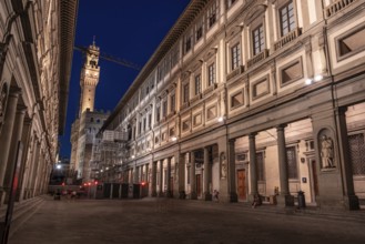 The famous Uffizi and the tower of the Palazzo Vecchio of Florence illuminated at night, Italy