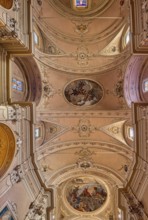 Stucco ceiling with frescoes in the catholic church of Santo Stefano