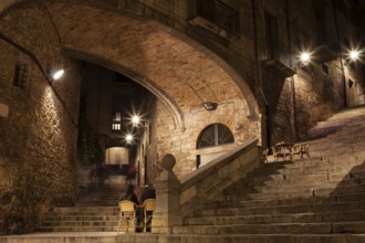Arch of the Agullana Palace and Sant Domenec stairs at night in Girona, Catalonia, Spain
