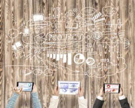 Group of three people with devices in hands working together as symbol of networking and