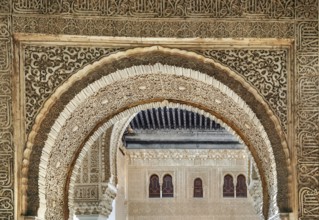 Arch with stone relief with arabesques in Alhambra palace, Spain