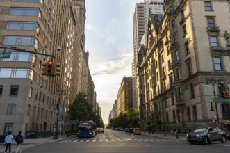 Street with old high buildings in Manhattan by Central Park, in New York City - USA