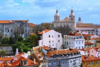 Lisbon, Portugal panoramic aerial view with colorful houses and Estrela Basilica cathedral towers