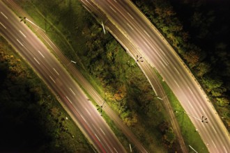 Top down view to road. Romantic night aerial photo of cars traveling. The light on the road at
