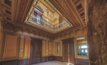 Magnificent staircase with ceiling fresco, framed by columns and elegant wooden doors, Villa