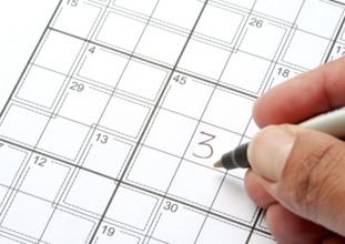 Solving a Crossword Puzzle with human hand writing a number