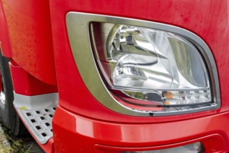 Headlight of a red truck
