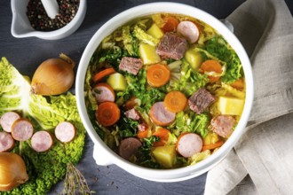 Delicious savoy cabbage soup in a white vase