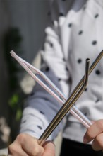 Woman holding Reusable Metal and plastic drinking Straws. Female Hand on reusable collapsible