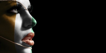 Ivory Coast flag painted on a face of a young woman, national flag on face